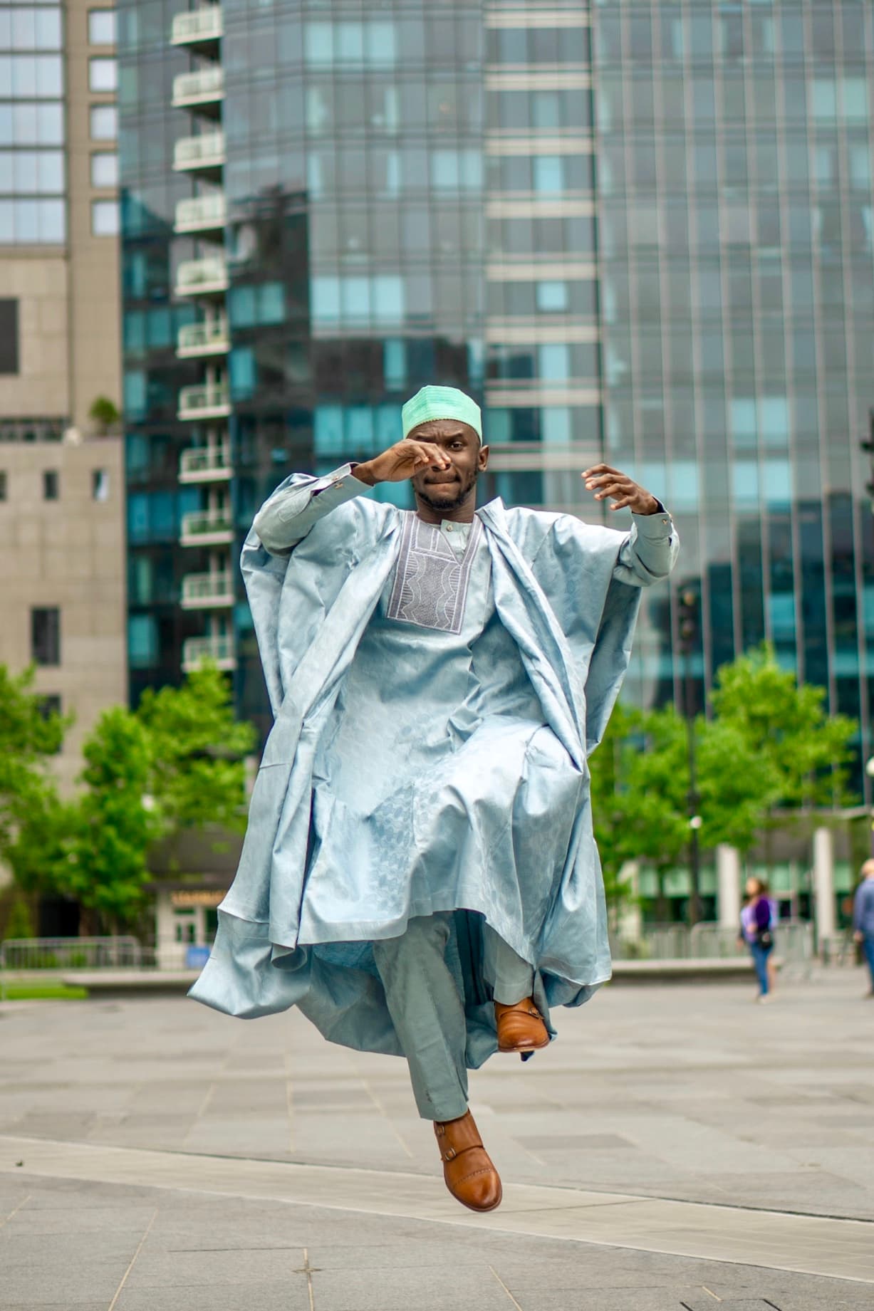 Lifestyle, man in agbada mid-jump at city plaza