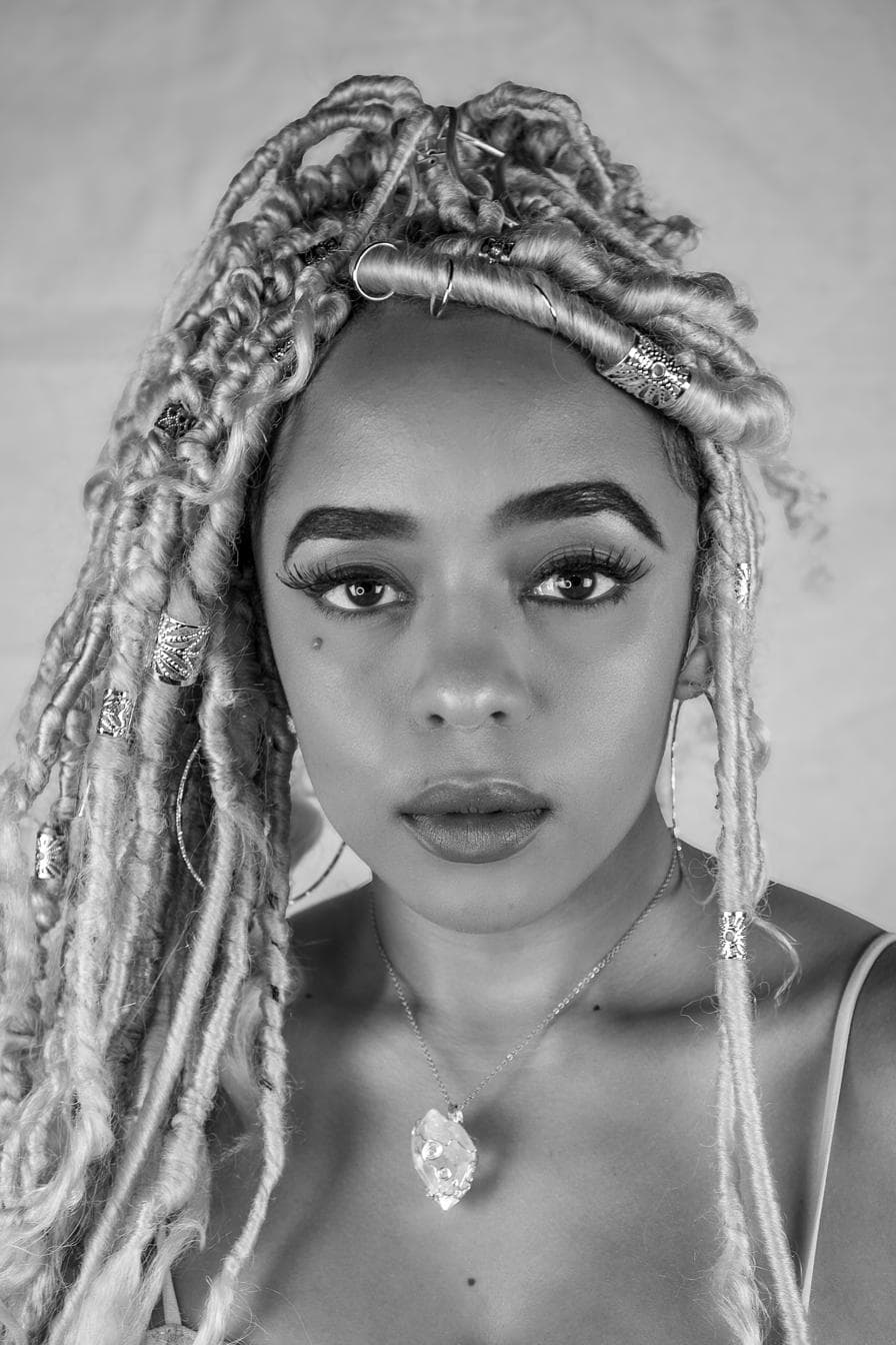 Editorial portrait, botanical setting, soft pink tones