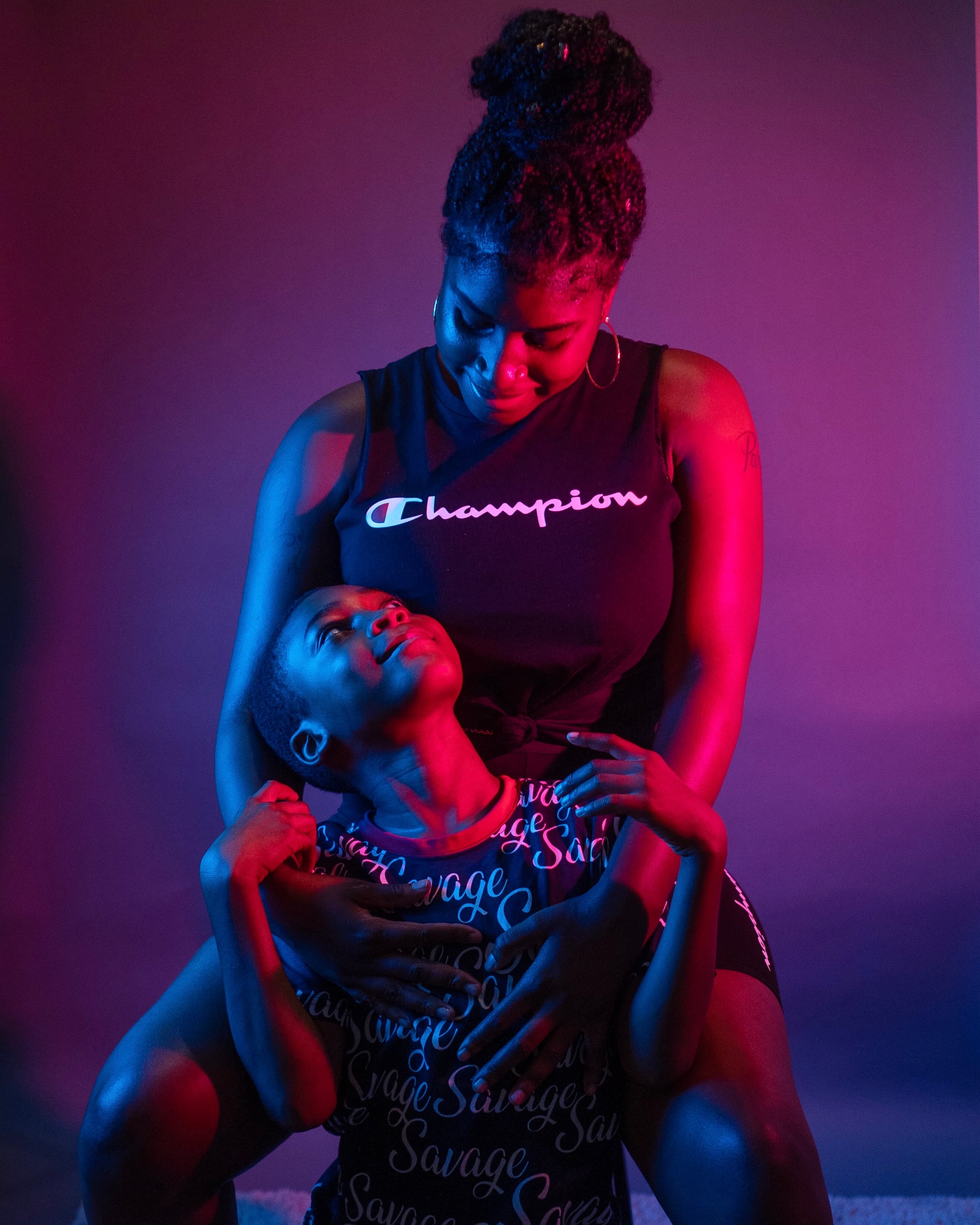 Neon portrait, mother and son in purple and red light