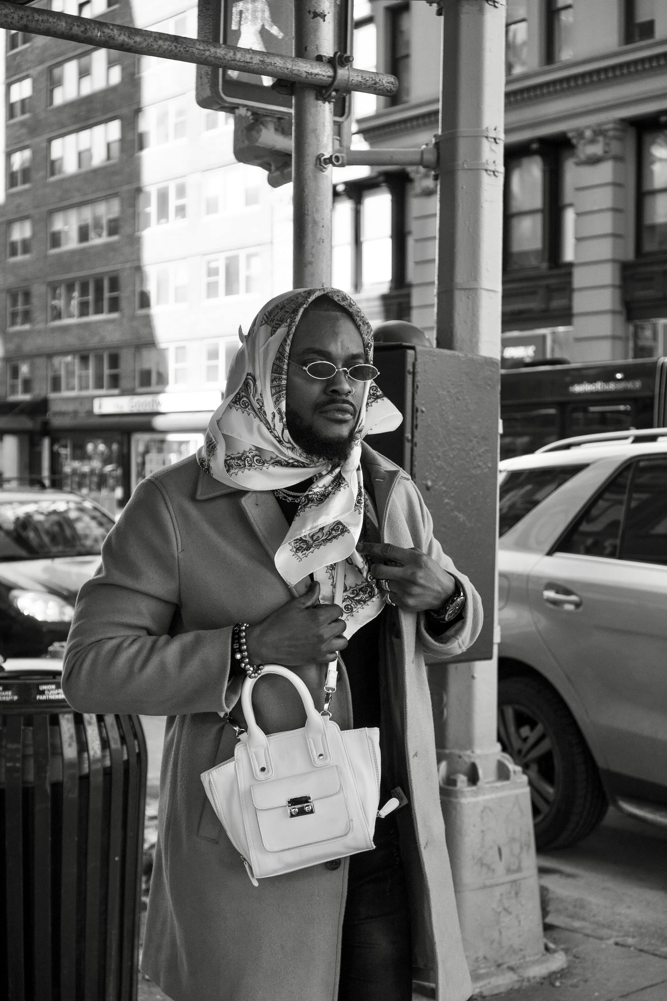 Monochrome street editorial, man in overcoat with headscarf, NYC