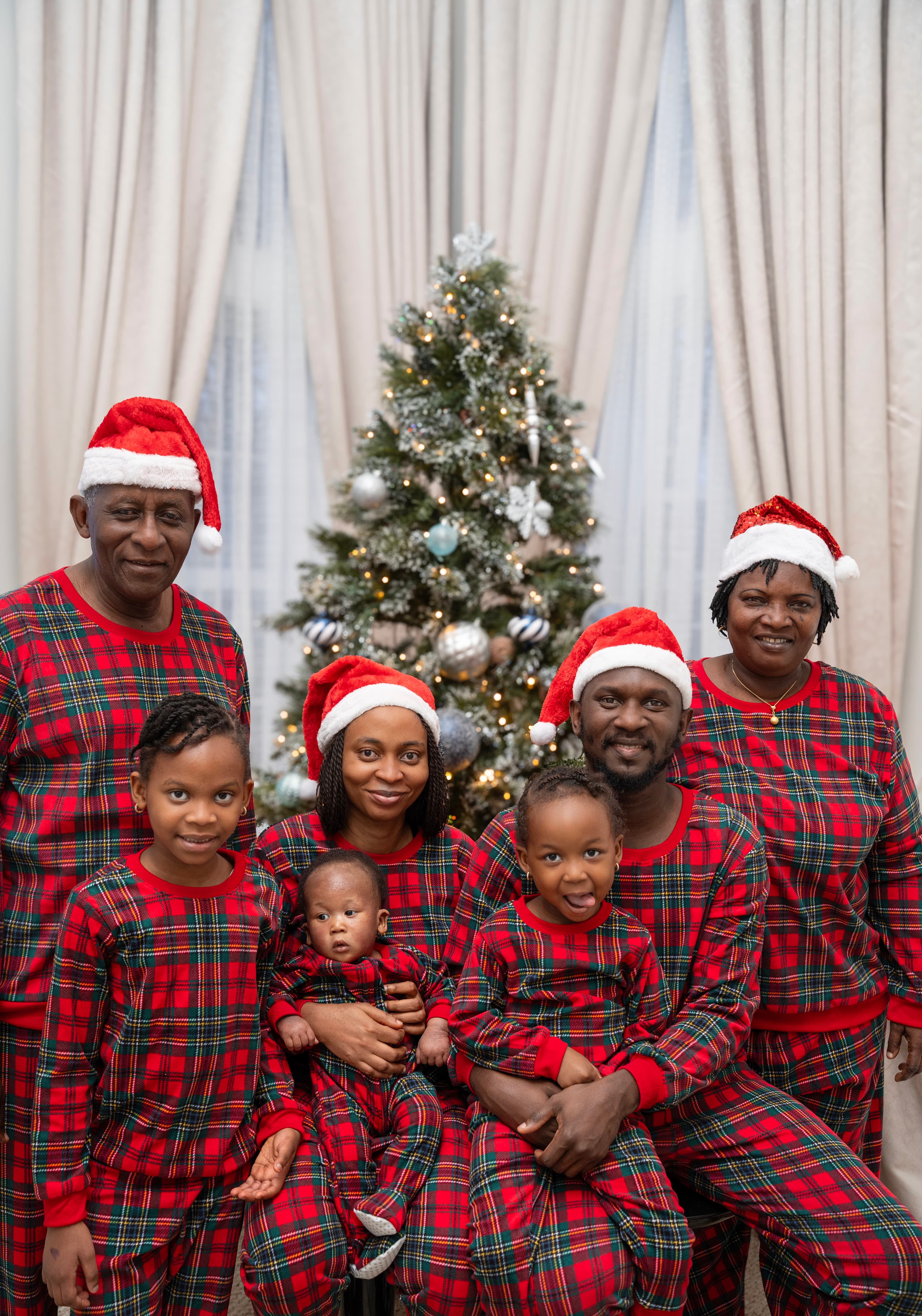 Family Christmas portrait, matching plaid pajamas
